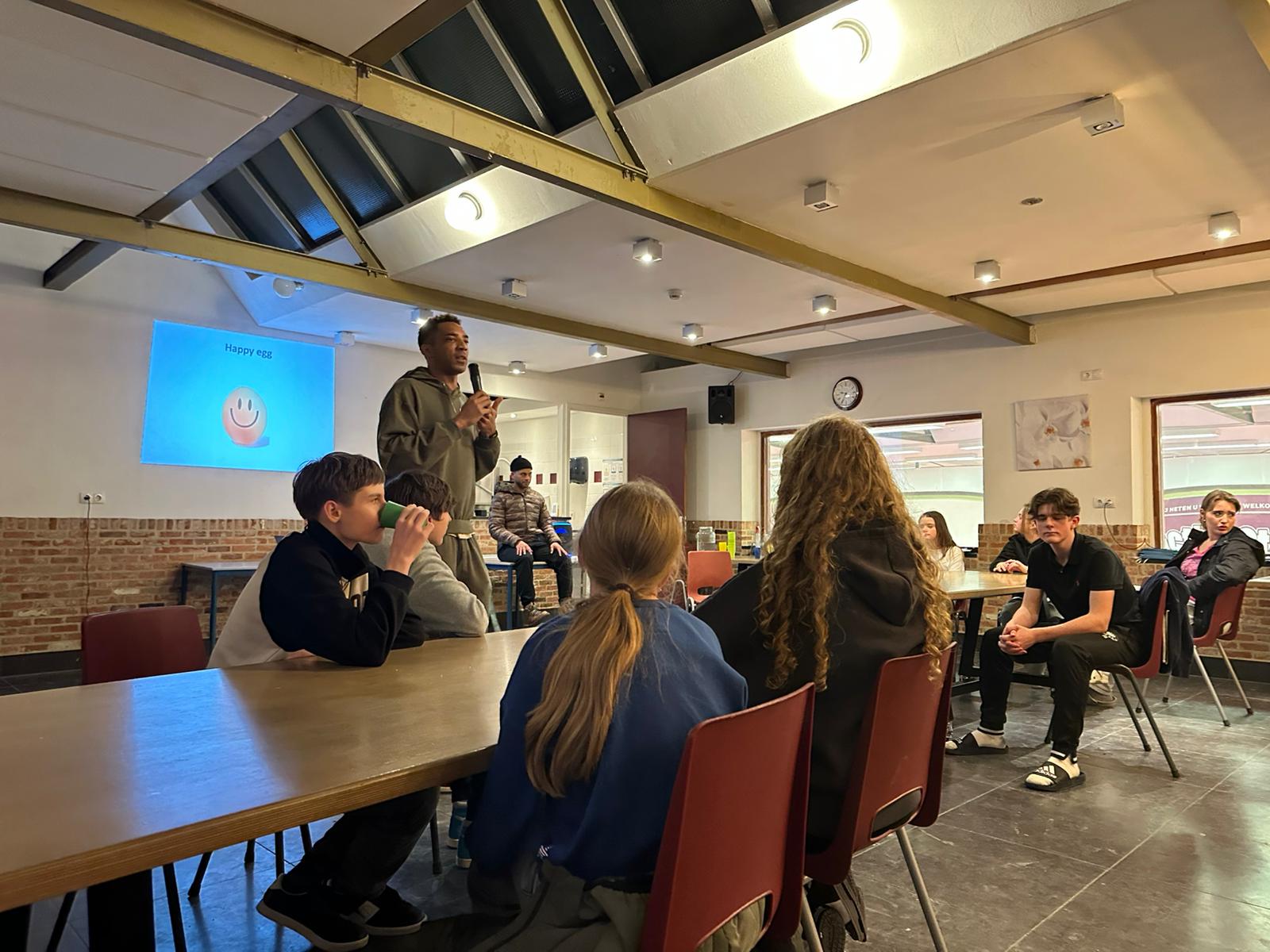 Egg drop briefing — 'Happy egg' projected on screen